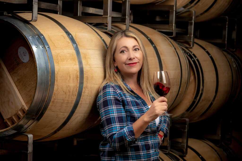 Sarah in the winery with barrels