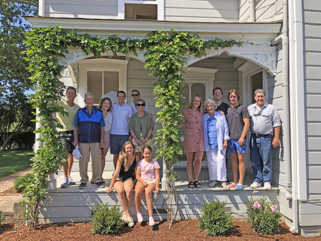 family gathered on farmhouse porch